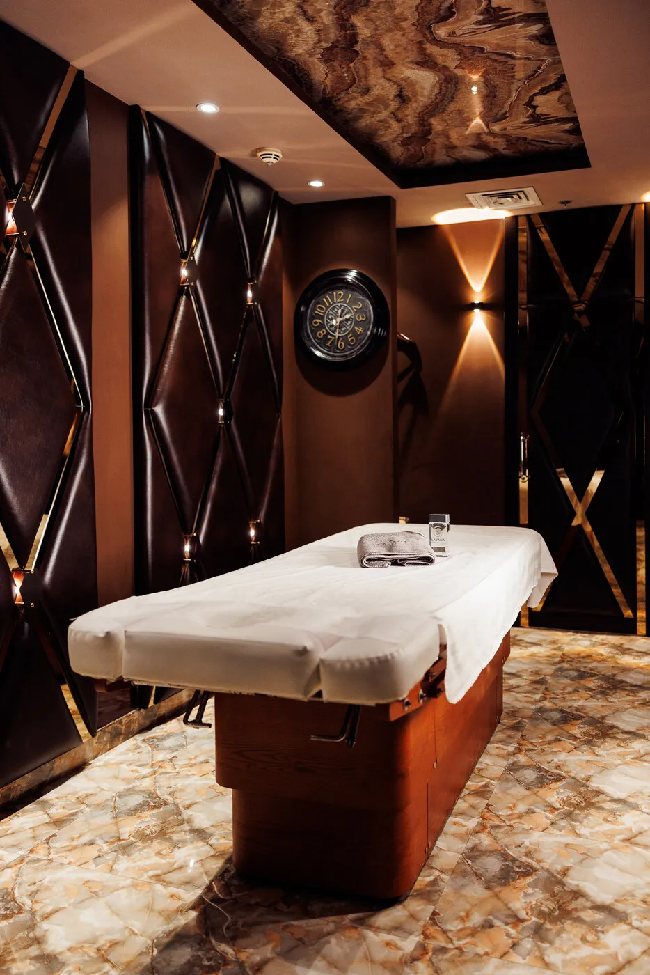 Massage room at Lavana Spa Al Barsha, with a marble wall and a single table